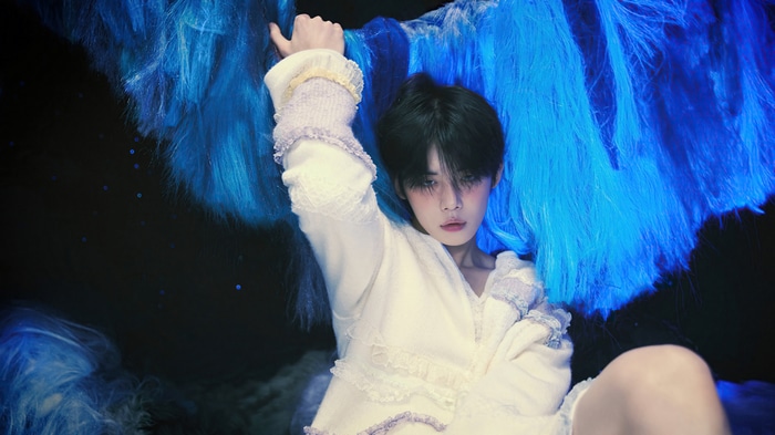 Yeonjun in white outfit with blue hair