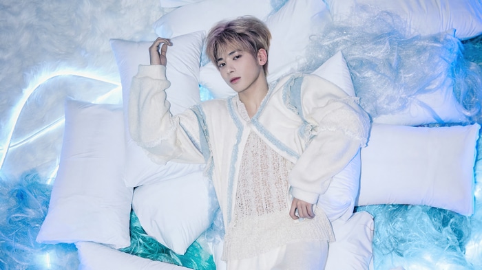 Taehyun from TXT lying on pillows