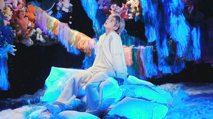 Taehyun from TXT sits on glowing pillows
