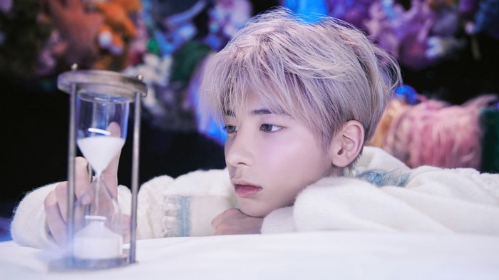 Taehyun of TXT with an hourglass