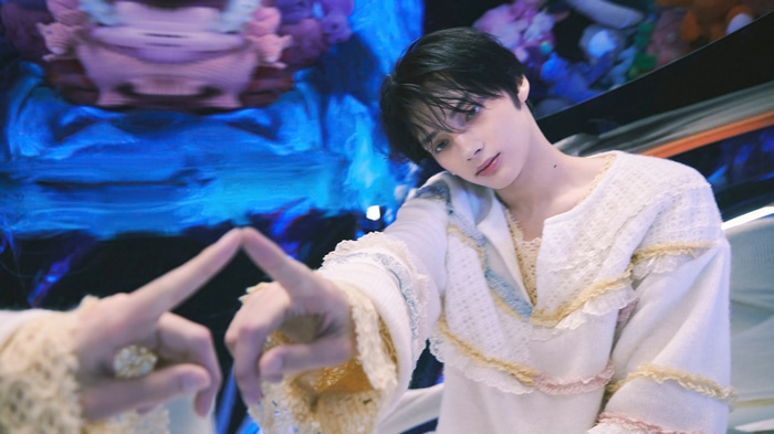 Huening Kai of TXT in ornate white clothing