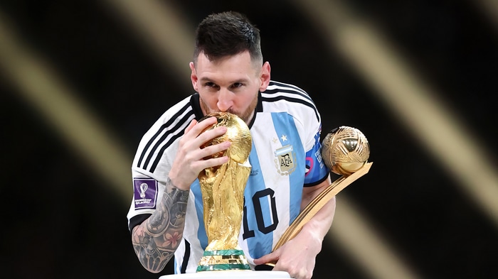 Lionel Messi kisses FIFA World Cup trophy