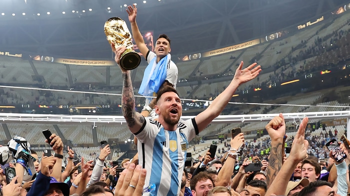 Lionel Messi and Lautaro Martinez celebrate with the FIFA World Cup trophy