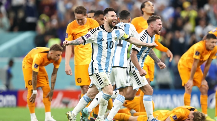Lionel Messi celebrates with teammates against Netherlands