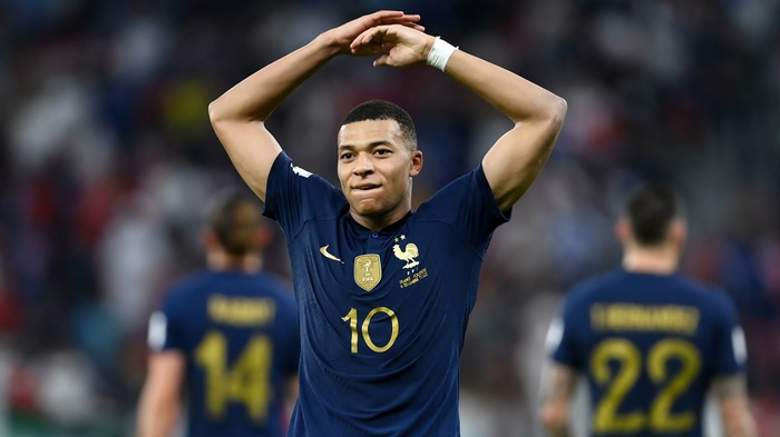 Kylian Mbappé of France celebrates with arms raised