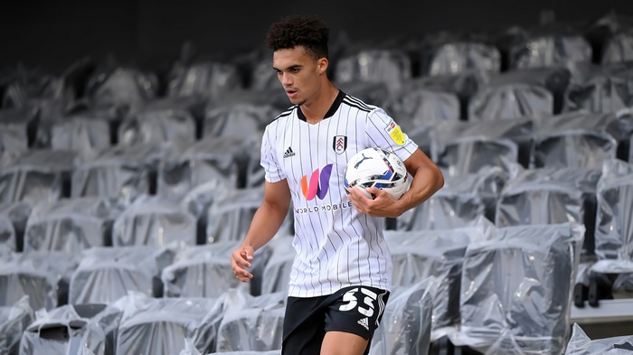 Fulham player holding a football in stadium