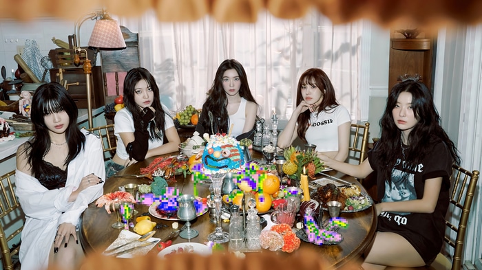 Red Velvet girls sitting at a table with a cake