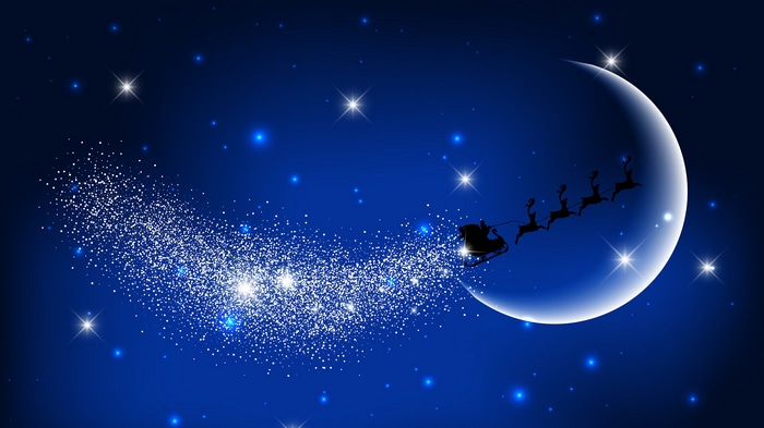 Santa Claus flying in a sleigh with reindeer