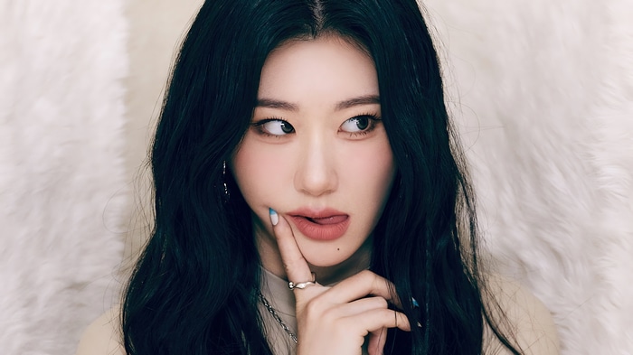 Chaeryeong from ITZY with dark hair and playful expression