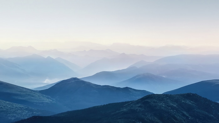 Mountain range shrouded in fog