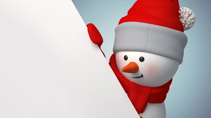Snowman peeking from behind a white board