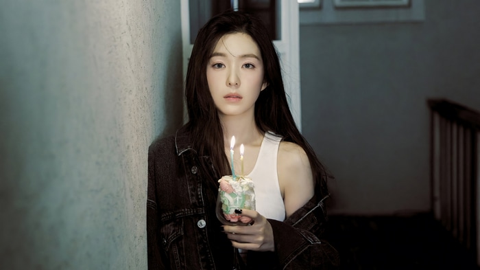 Irene holding a birthday cake with candles