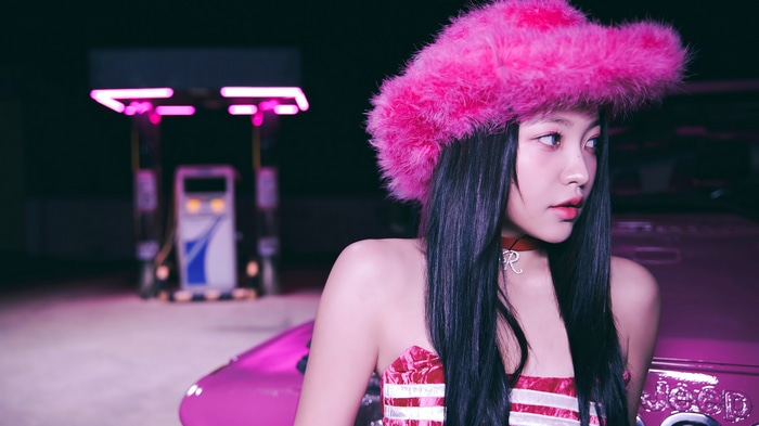 Yeri in a pink fluffy hat at a gas station