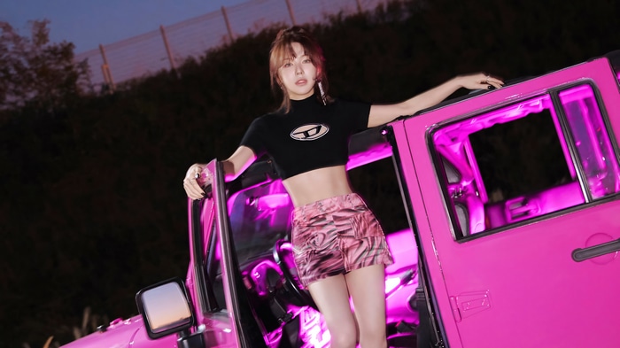 Wendy from Red Velvet posing by a pink car