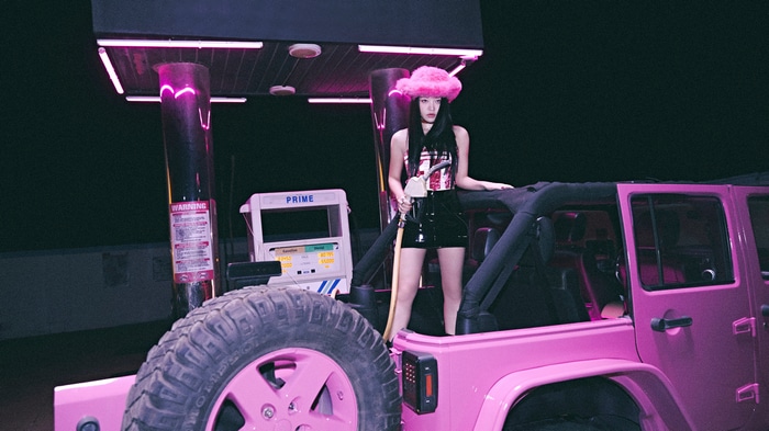 Yeri in a pink Jeep at a gas station
