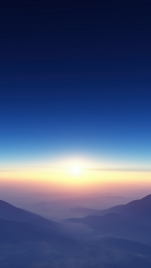 Sunrise over misty mountains