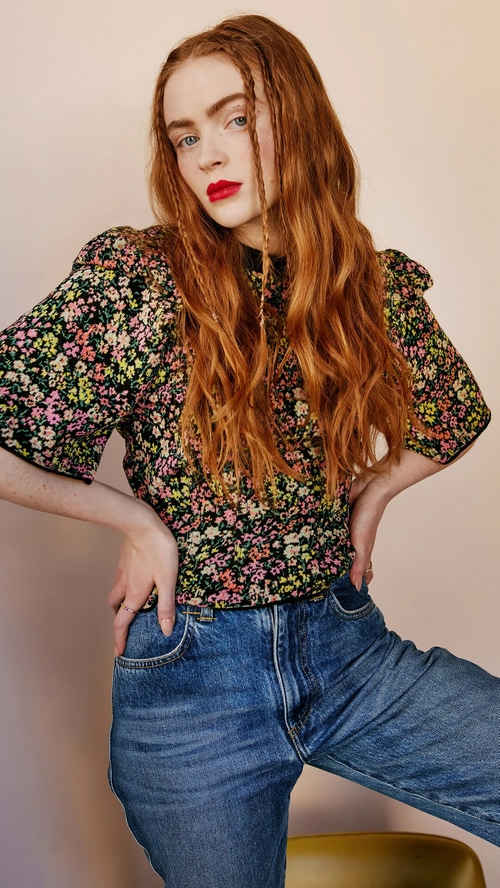 Sadie Sink in floral top and blue jeans