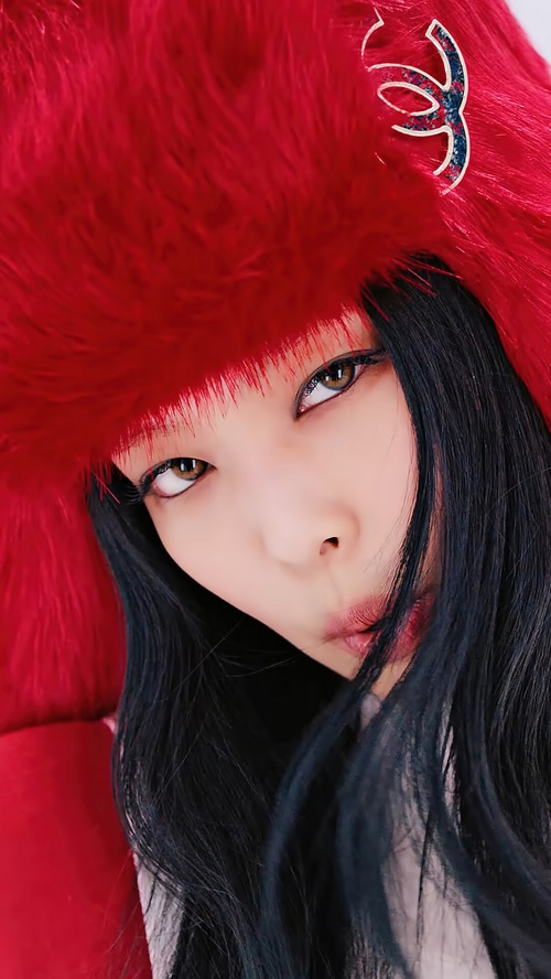 Jennie Kim from BLACKPINK wearing a red fur hat