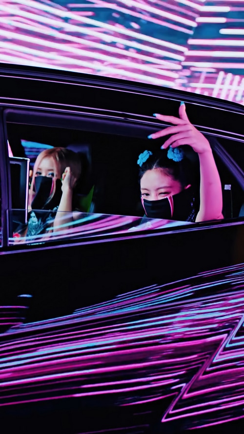 BLACKPINK members in a car with neon lights