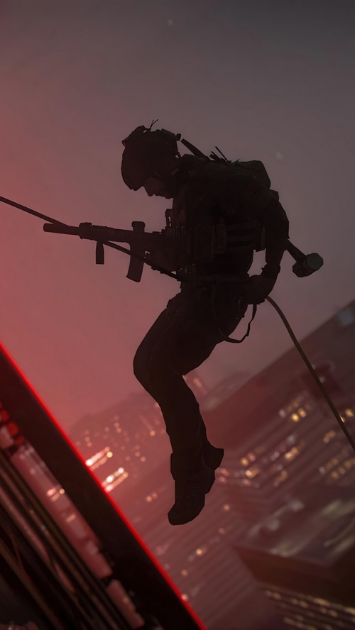 Soldier rappelling down a building at dusk