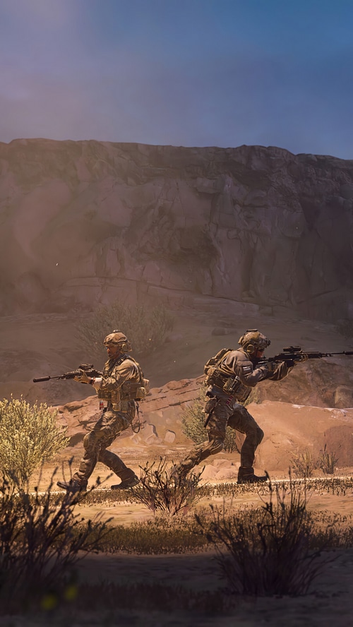 Soldiers in tactical gear running through a desert canyon