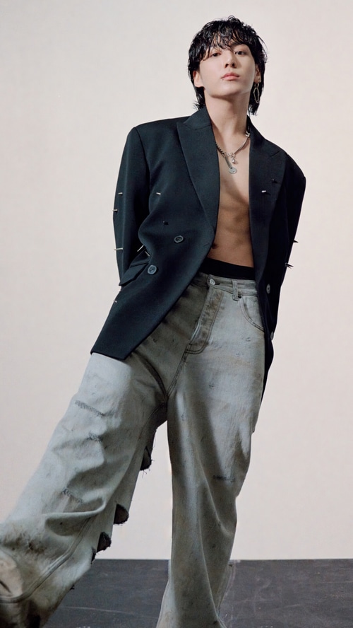 Jungkook in a black blazer and ripped jeans