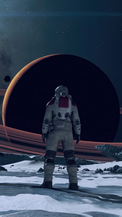 Astronaut on a snowy planet with a ringed planet in the background