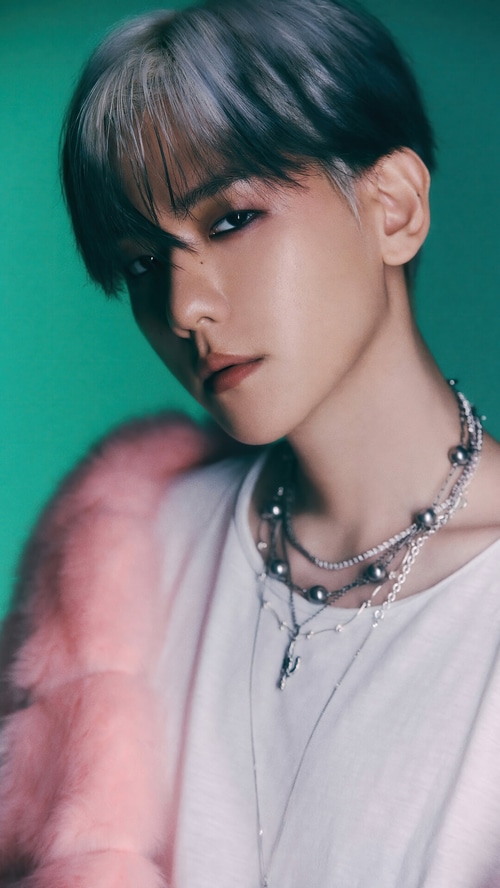 Baekhyun wearing necklaces and a pink fur coat