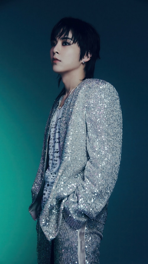 Xiumin in a sparkling silver jacket