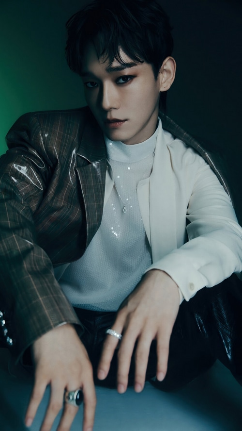 Chen from EXO wearing a unique jacket and jewelry