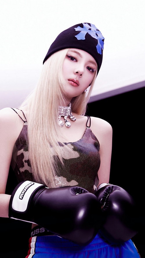 Lia from ITZY wearing boxing gloves and a beanie