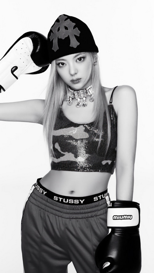 Lia from ITZY wearing boxing gloves and a beanie