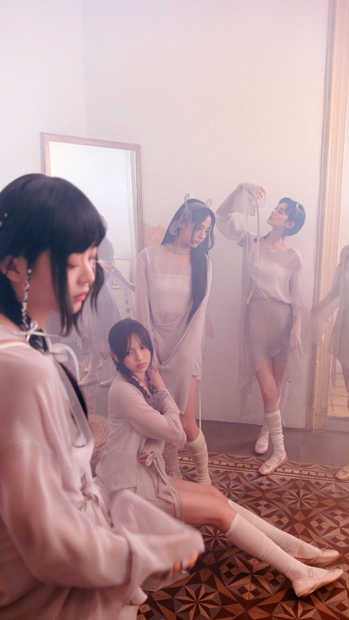 NewJeans members in ethereal outfits