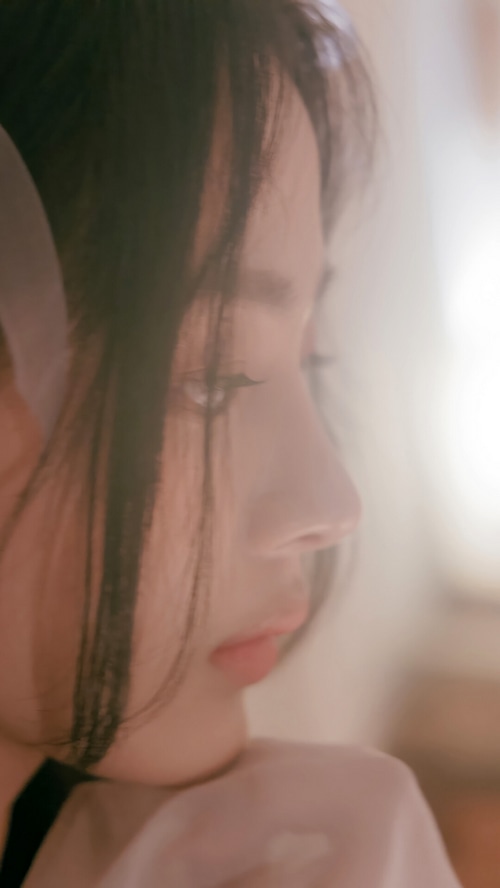 Minji from NewJeans in a close-up profile shot