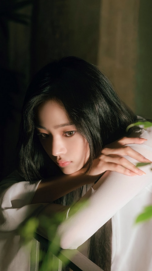 Minji from NewJeans in a white top