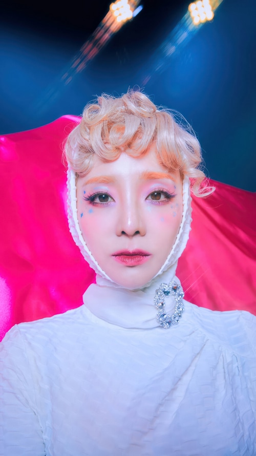 Sandara Park in a white outfit with pink fabric