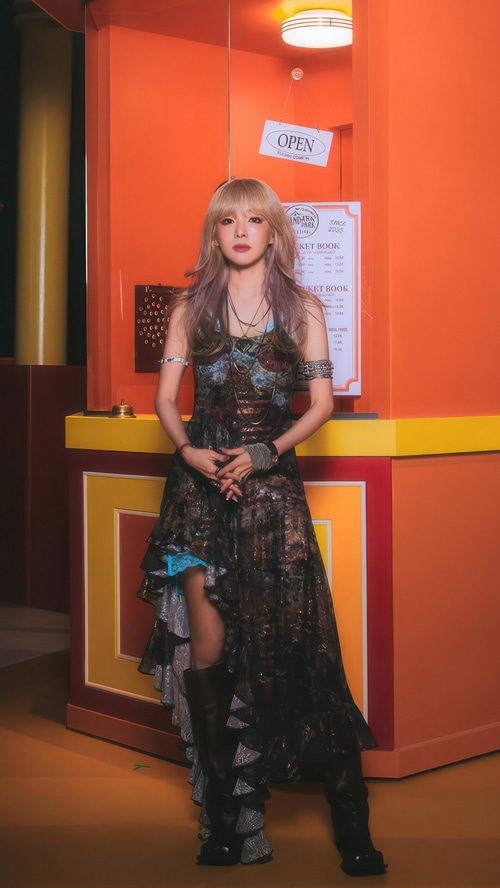 Sandara Park in a dark patterned dress