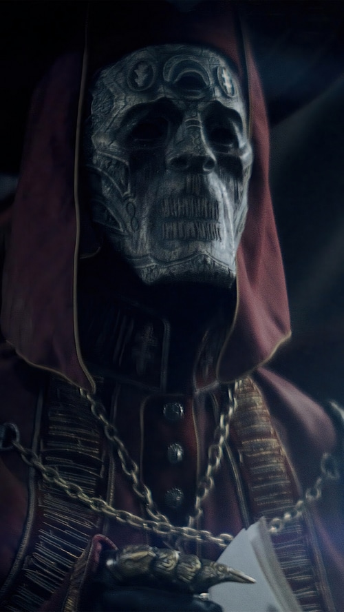 Rebel Moon character with skull mask and red hood