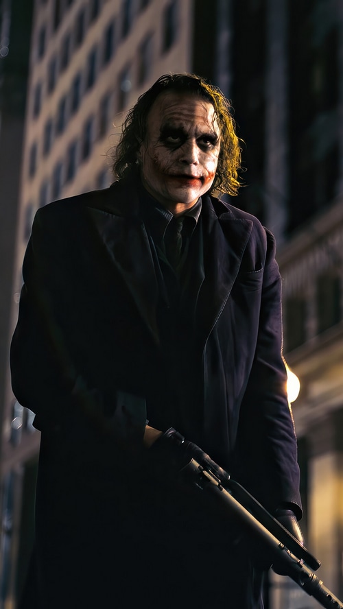 The Joker holding a shotgun in a city