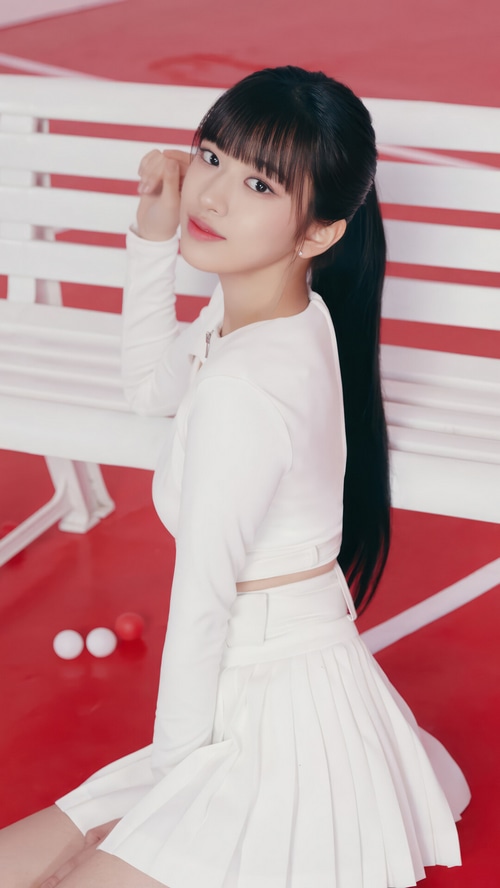 Yujin from IVE in a white outfit