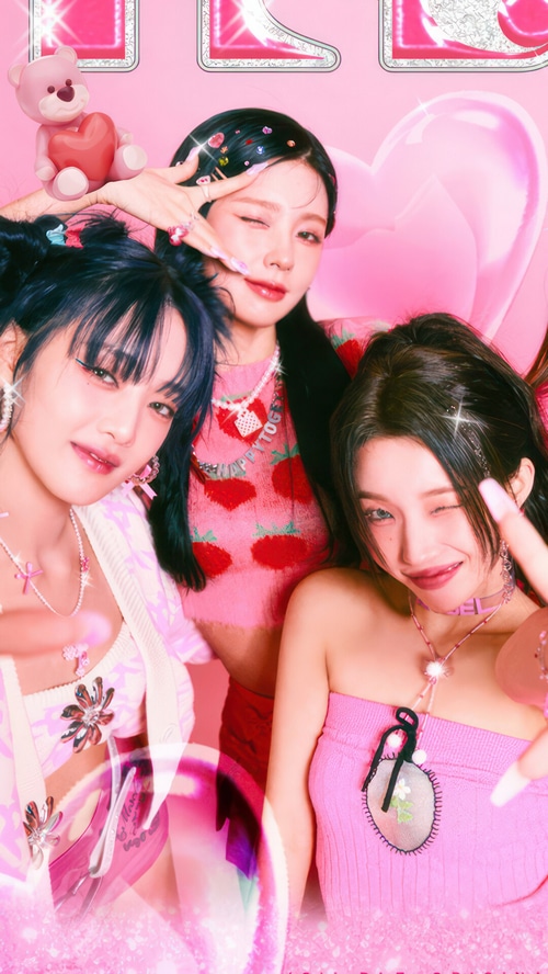 GIDLE members posing in pink outfits with strawberry motifs