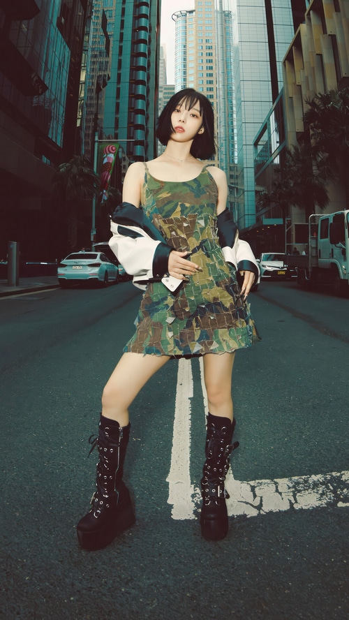 Winter from Aespa in a camouflage dress and platform boots