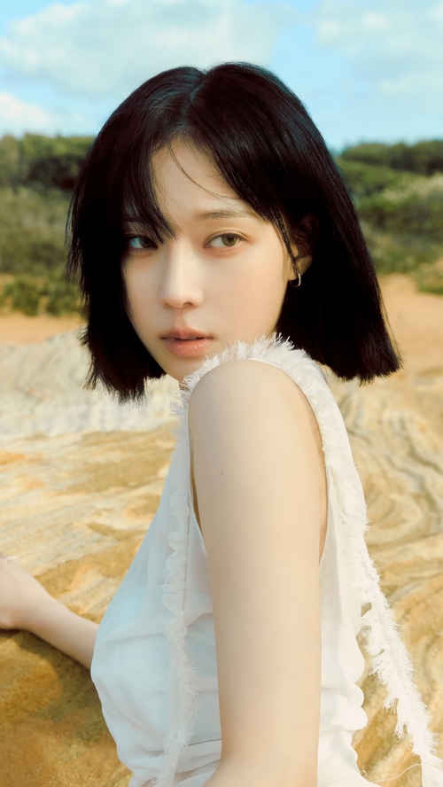 Winter from Aespa in a white dress outdoors