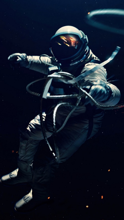 Astronaut floating in space with cables