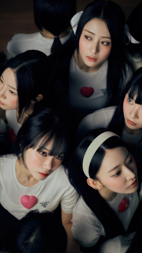 LE SSERAFIM members in white shirts with pink hearts