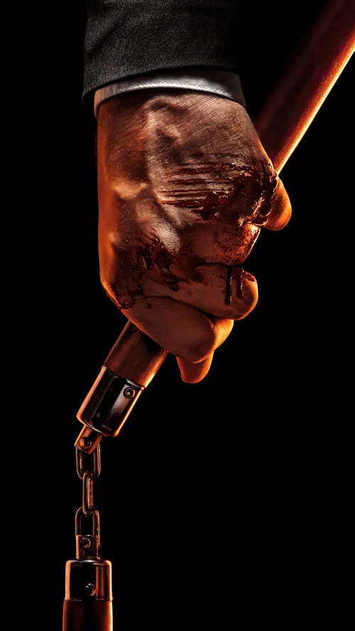 John Wick holding bloody nunchucks