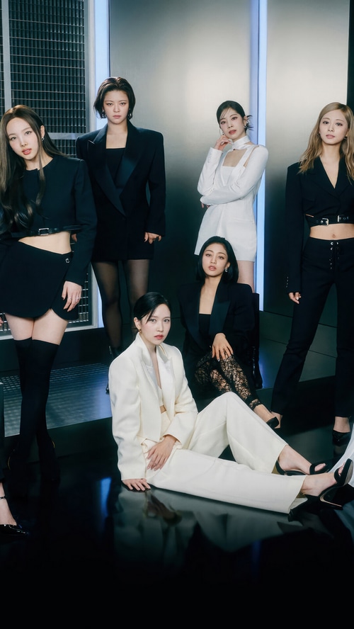 TWICE members in black and white suits