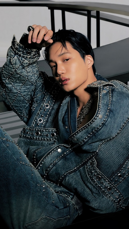 Kai wearing a studded denim outfit
