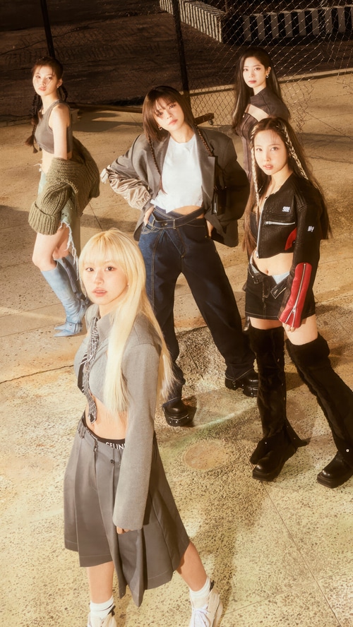TWICE members posing in stylish outfits