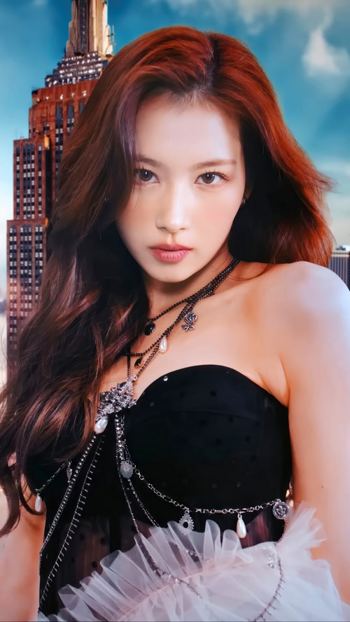 Sana from TWICE in a black strapless outfit with necklaces